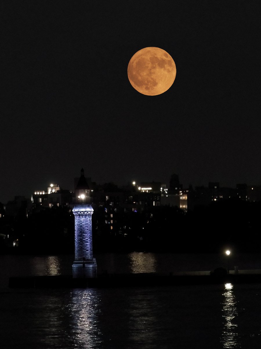 Tuesday night's full Strawberry Moon over the East River as seen from Manhattan. Smoke particles give it an orange hue.