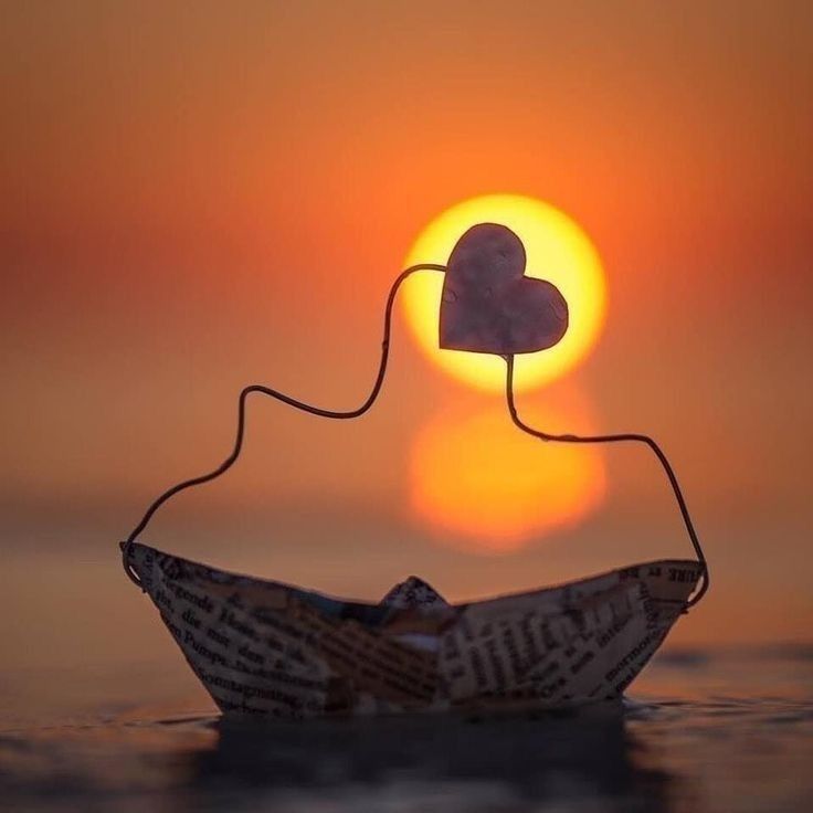A paper boat drifts on twilight's breath,
carrying a heart toward the sun.
Love sails quietly—
between a fading light
and the promise of tomorrow.