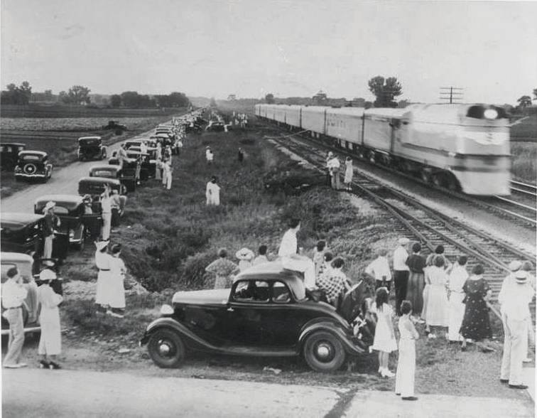 Folks gather next to the right-of-way to watch one of the Milwaukee Road's new "Hiawatha's" (Chicago - Twin Cities) rush past at-speed (approaching 100 mph), led by a 4-4-2 (Class A), in the late spring (May/June) of 1935.

american-rails.com/hiawatha.html