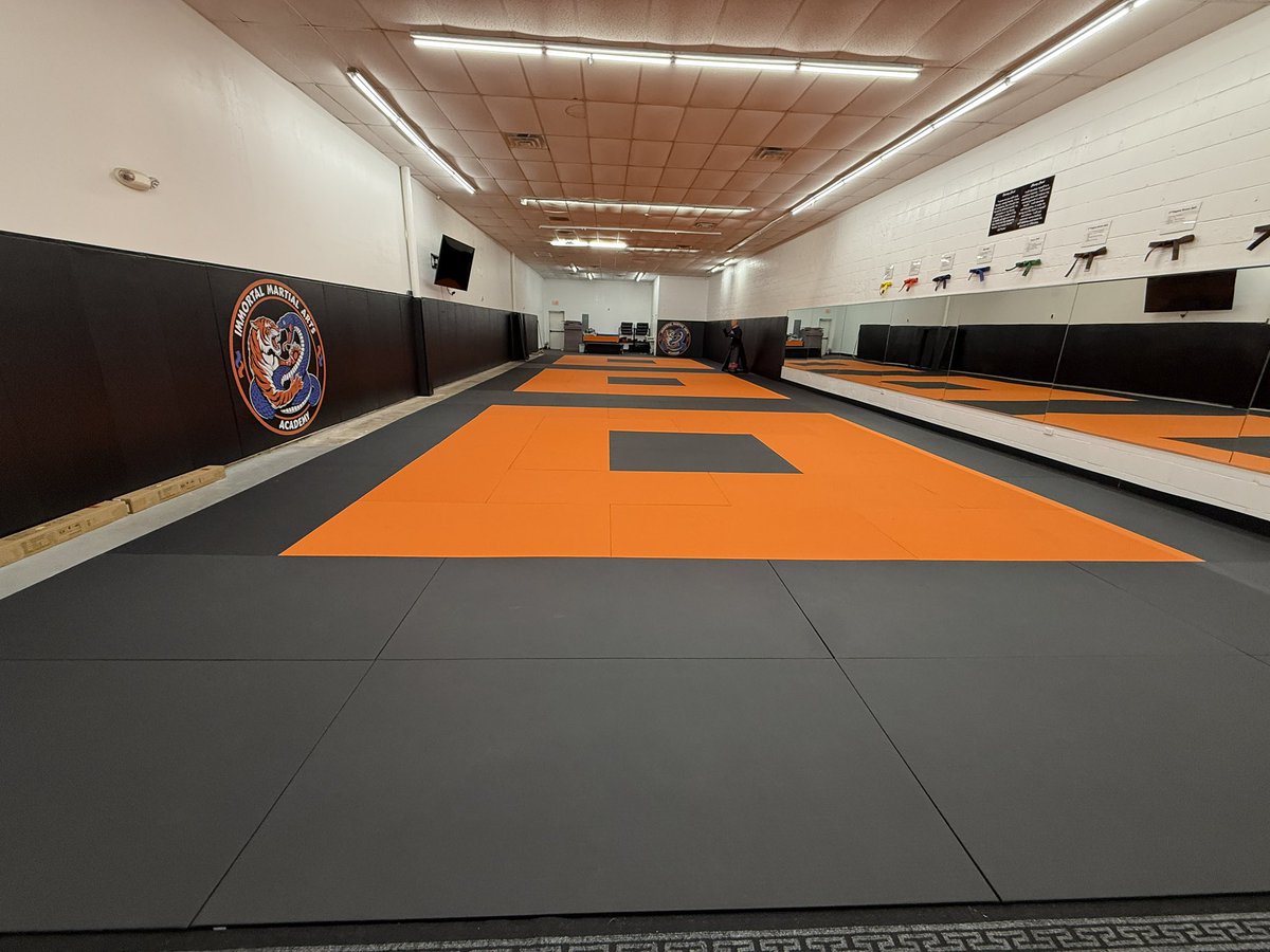immortalmaa's tweet photo. The rest of our mats arrived yesterday! Big shout out to our whole team and the 2 dads who worked hard to get them unloaded and laid down last night. The back wall where concrete is still exposed will get filled in later once we custom cut the last 13 black mats to fit there. https://t.co/5LWIfY5PZA