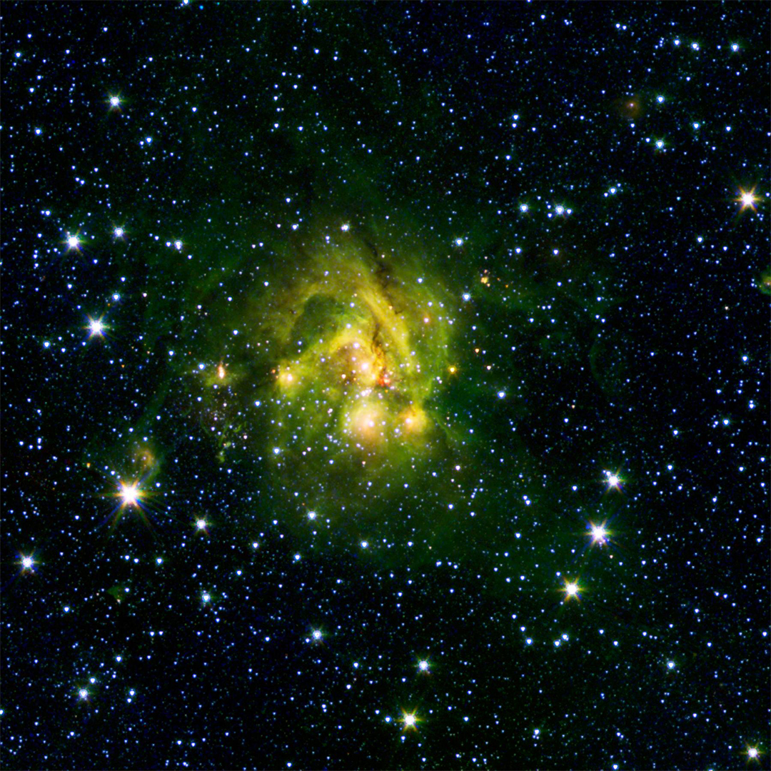 In the middle of the picture, a lime green cloud of gas catches your eye in a citrusy splash of color. Blue and yellow dots of light are visible through the cloud, which is most concentrated at the center, but spreads outward in several tendrils. All around the cloud are many blue stars of varying brightness and the darkness of space.⁣ Credit: NASA/JPL-Caltech/2MASS/SSI/University of Wisconsin⁣