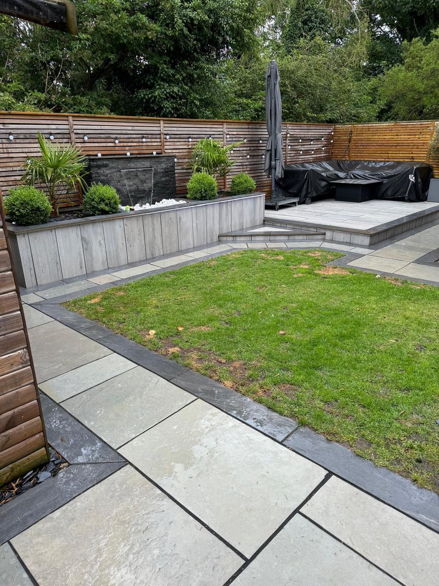 What a beautiful garden transformation by T.J.W Services! 🌿💦 

They’ve created a real showstopper with this sleek water feature using our Galaxy Quartz Wall Cladding, perfectly paired with Padoak Grey Porcelain 1200x300 for a warm, modern look on the walls.

#pavingstonesdirect