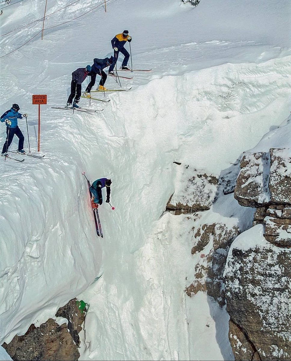 Extreme skier Doug Coombs going down a steep slope, 1989.

Coombs was a skiing icon and pioneered hundreds of untested descents around the world. He was also the first winner of the World Extreme Skiing Championships in Alaska, 1991 and was considered by many to be one of the