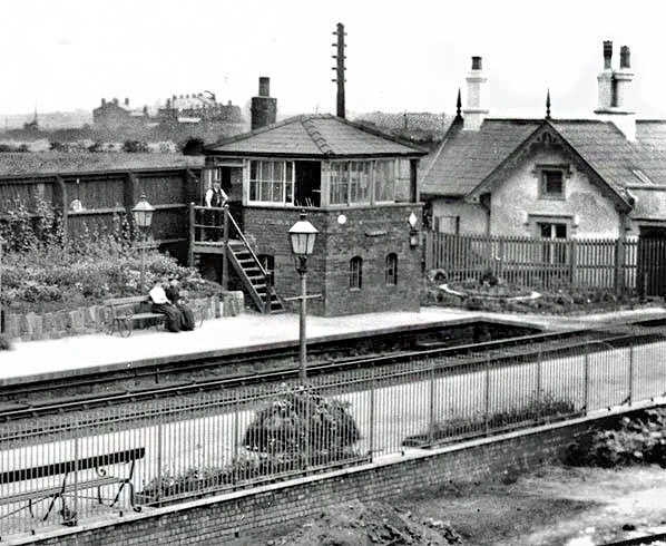TrainStations23's tweet photo. Looking south-east towards Farnworth & Bold station in the summer of 1904.  

The station building is just out of view to the right.  Prominent in the view is the Saxby and Farmer signal box on the down platform.
The station gardens appear to be very well maintained.

Photo and information by Richard Mercer