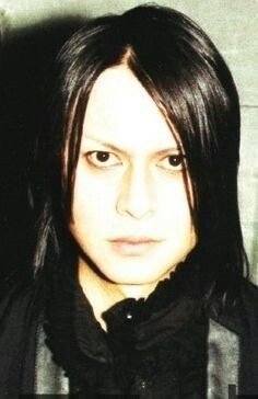 he looks like the possessed little girl in a horror movie