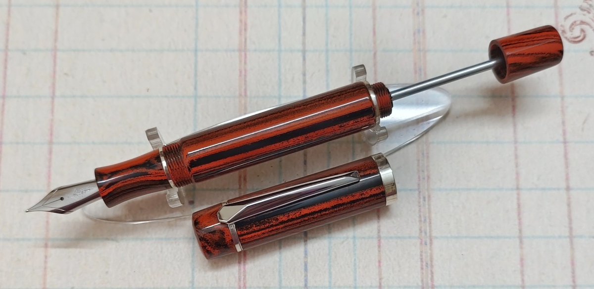Custom pen using Conway Stewart woodgrain ebonite. Built-in plunger filler and sterling silver bands.