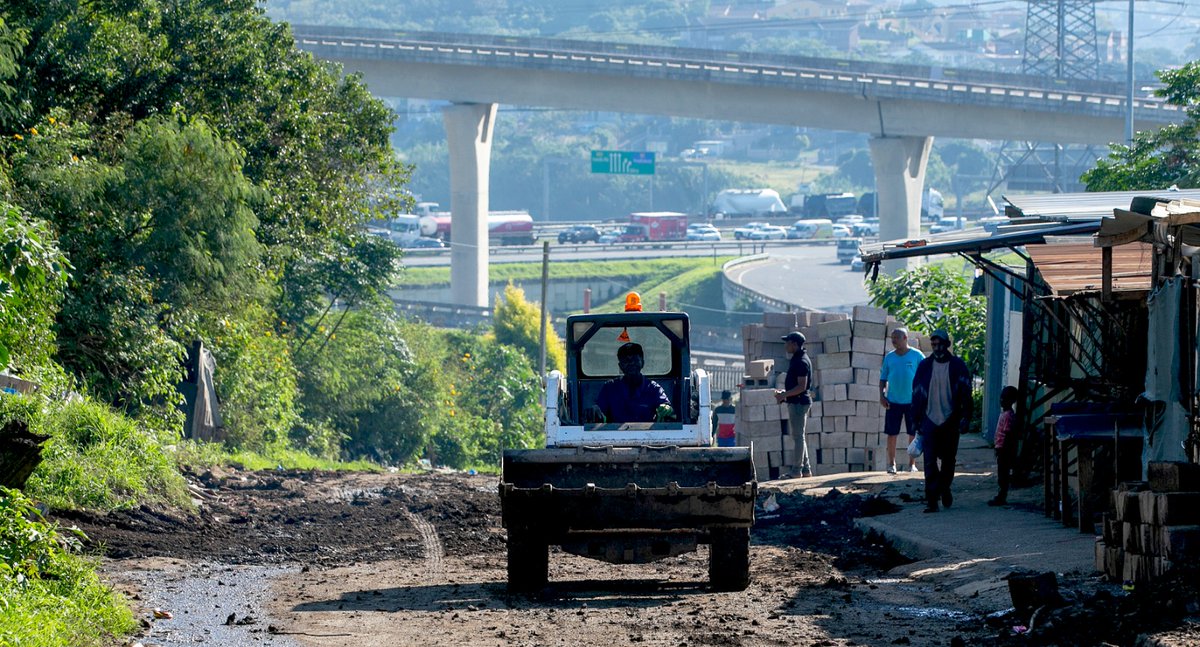 TheMercurySA's tweet image. South Africa - Durban - Transport operators frustrated with the poor state of Kennedy Road in Clare Estate hired a grader to fill in potholes and make the road drivable. 
Photographer: Leon Lestrade / Independent Newspapers
#transportoperator #frustration #KennedyRoad #themercury