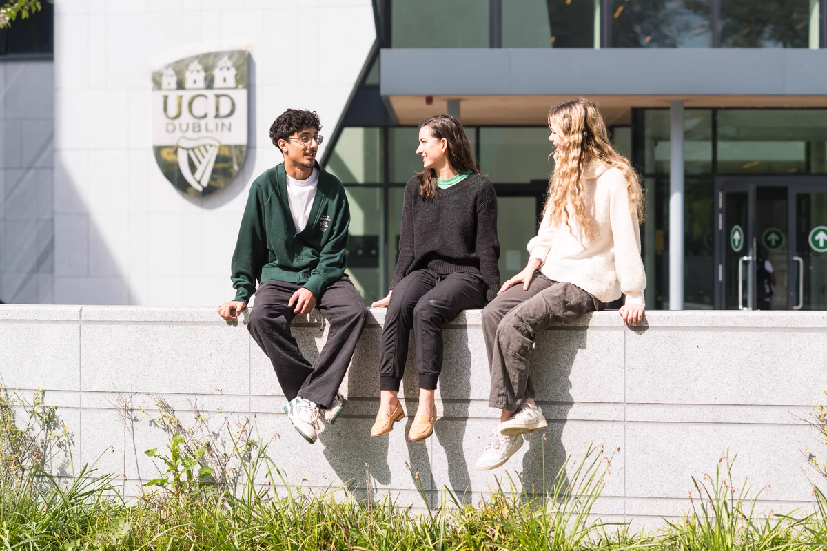 Students sitting in front of UCD O'Brien Centre for Science main entrance.