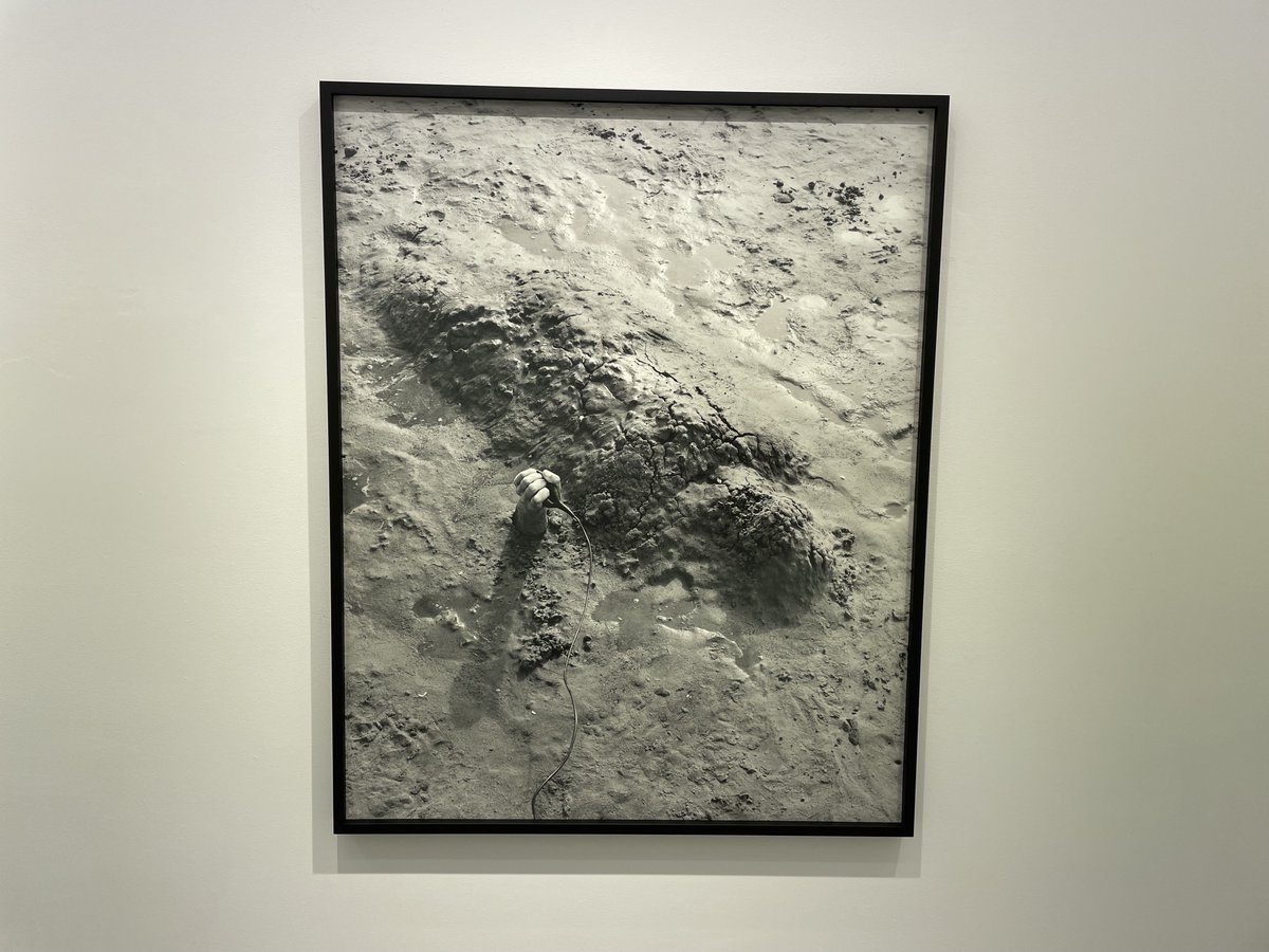 Daybook: A single hand emerging from dark wet sand. Jenny Calivas (from 2021) in the project room at Yancey Richardson Gallery. collectordaily.com/jenny-calivas-…