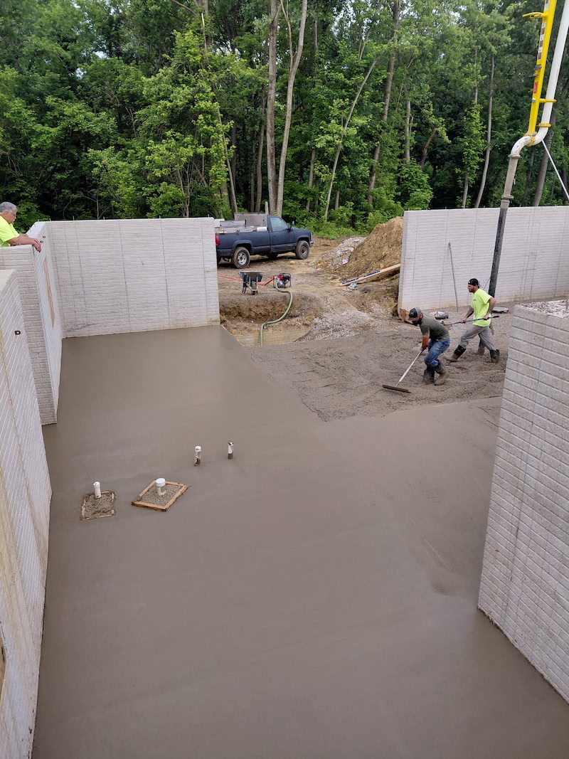 A pour day is always a fun day (and NOT a poor day). Basement slab outside of Columbus, OH. Foundation walls were poured previously. Basement has 2 egress windows for 2 bedrooms. Underground plumbing for a bathroom. Spec build that is already under contract. Our partner is Chad