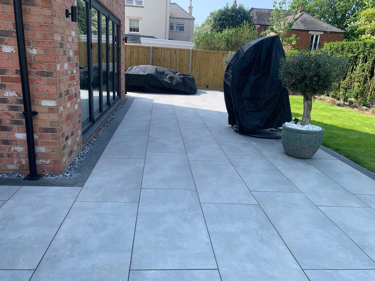 Take a moment to admire this breathtaking patio masterpiece by T.J.W Services!!  

They've skillfully crafted this patio with our Storm Grey Porcelain 900x600 and Anthracite Porcelain 900x200. And just look at that water feature framed by our New York Grey Wall Cladding.