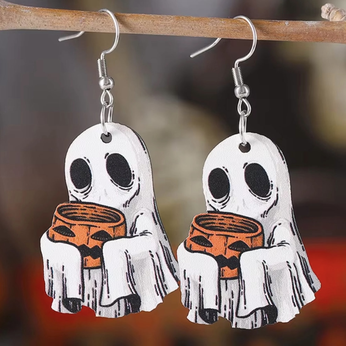 Haunt in style with these wooden earrings, showcasing a delightfully cute ghost clutching a pumpkin bucket! Each charm, measuring just under 1.5", is crafted to be lightweight &amp; comfy to wear. A must-have for Halloween &amp; paranormal enthusiasts alike! Info: wickedlywilliams.com/products/trick…