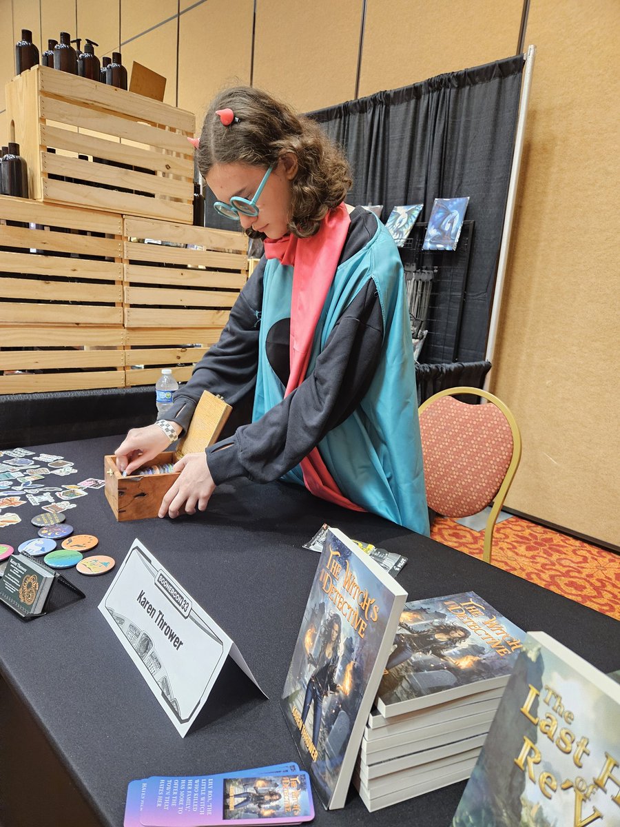 Maisery9's tweet photo. My lil Ralsei helping me sell books! #deltarunecosplay #soonercon #indiewriters https://t.co/aG2upRtBOC