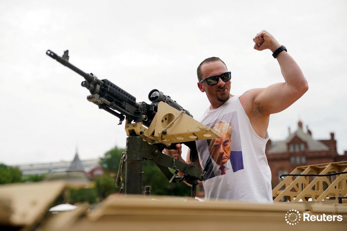 corinne_perkins (@corinne_perkins) on Twitter photo <a href="/SmileItsNathan/">Nathan Howard</a> A Trump supporter wearing a shirt depicting Trump’s mugshot poses with a weapon on the day of a military parade to commemorate the U.S. Army's 250th Birthday in Washington, D.C. Photo by <a href="/SmileItsNathan/">Nathan Howard</a> <a href="/SmileItsNathan/">Nathan Howard</a> A Trump supporter wearing a shirt depicting Trump’s mugshot poses with a weapon on the day of a military parade to commemorate the U.S. Army's 250th Birthday in Washington, D.C. Photo by <a href="/SmileItsNathan/">Nathan Howard</a>