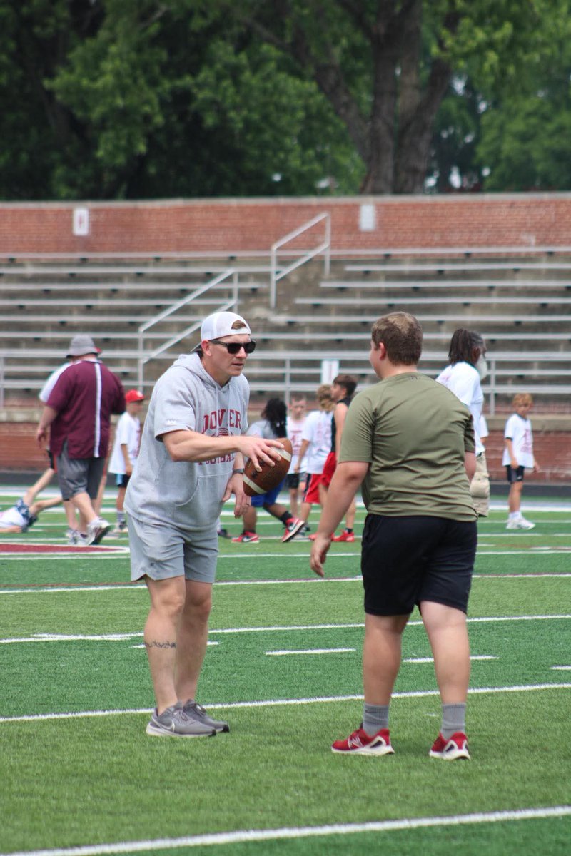 Dover High football Coach Matt Rees gives instructions to a young camper at the Dover Youth Football Camp in concert with the Browns Backers of T-County. Big TIME SPORTS was there. 👍😊