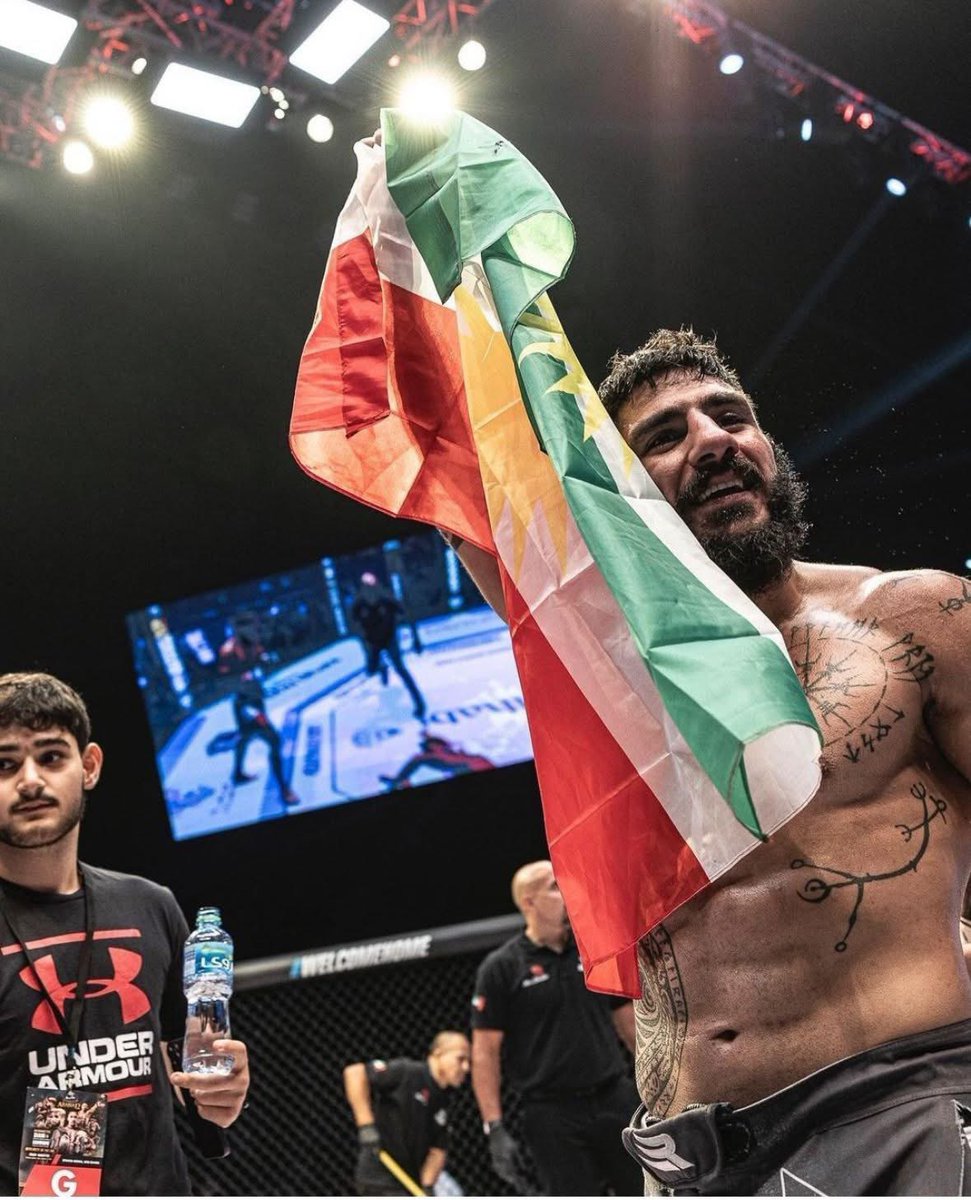 HoshangSulaiman's tweet photo. Kurdish martial arts champion Namo Fazil has achieved a remarkable victory, defeating Yaqub Suleimanov in the prestigious #971FC tournament held in Dubai. By proudly raising the #Kurdish flag in the arena he delivered a powerful message of strength, resilience, and national pride https://t.co/WdD1JGSegS