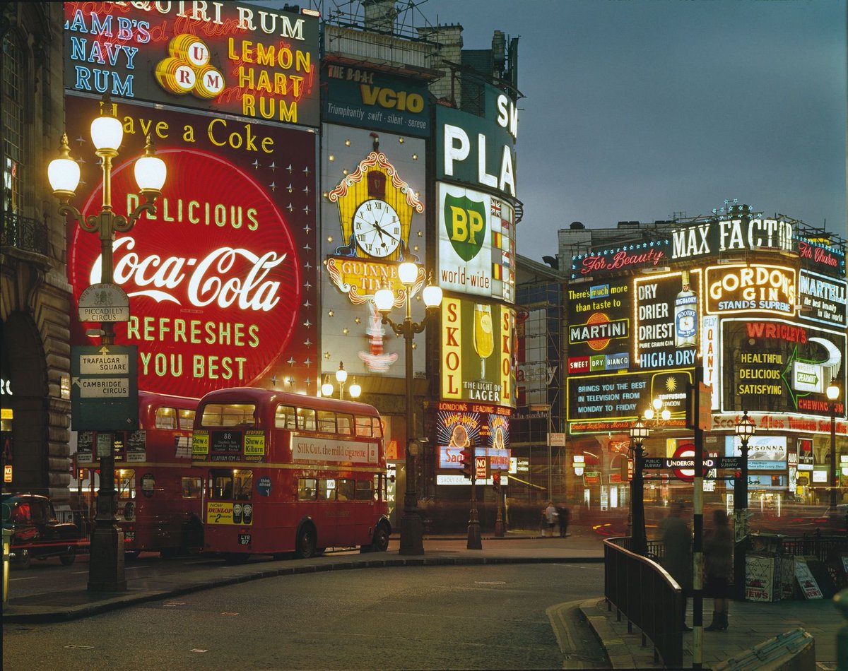 Piccadilly Circus in 1965, a hub of Swinging London, where youth culture exploded with fashion and music.