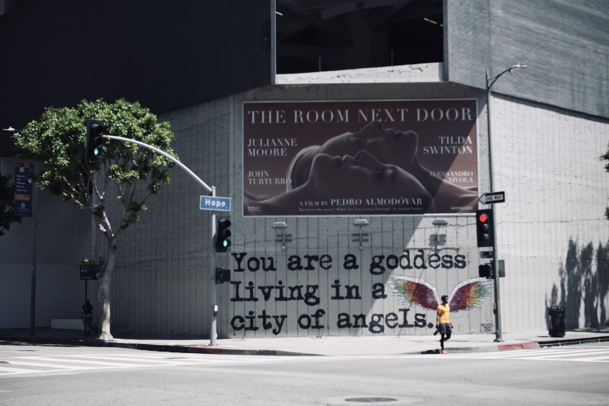 A guy crosses the street in downtown L.A. showcasing the perfect moment where, humans, angels and hope align.

And maybe a dash of good composition;)