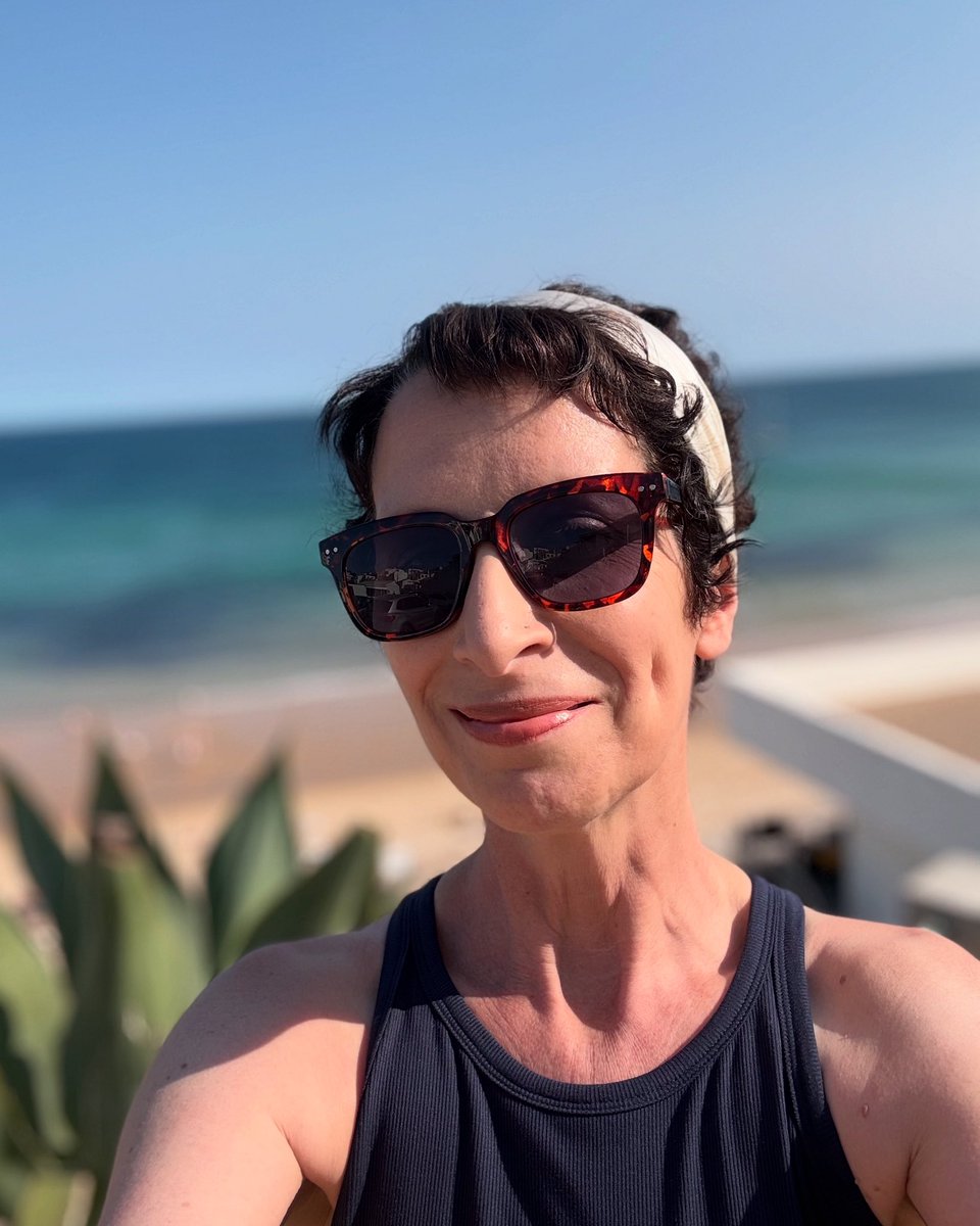 Picture on the left, one year ago today, just about to lose my hair for the first time from chemo. Picture on the right, last week in Portugal. I love my new crazy curly hair so much. My reward for all the shit. #fuckcancer