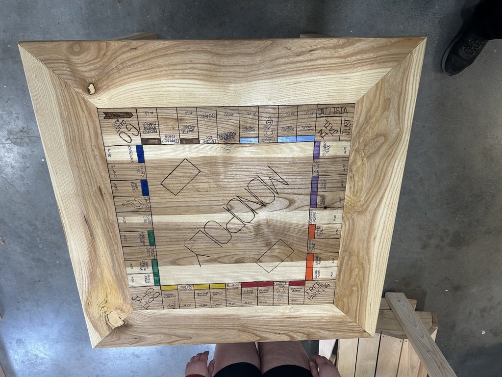 Emma built a nice Monopoly table out of ash.  She had a fun time wood-burning and painting her game board.  The middle flips over and turns into a normal table.  Good job, Emma!