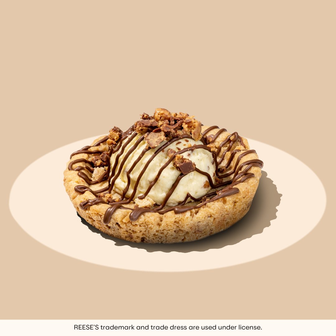 crumbl's tweet photo. if a dessert could serve face and flavor it would be this one. peanut butter cup skillet cookie ft. REESE'S 🤎 is fresh out of the oven and in the building. tag your pb bestie 👇 https://t.co/GL5wDV1nDi