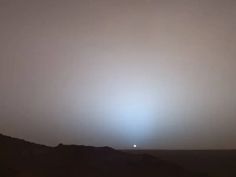 On May 19, 2005, NASA's Mars Exploration Rover Spirit captured this stunning view as the Sun sank below the rim of Gusev crater on Mars. This Panoramic Camera mosaic was taken around 6:07 in the evening of the rover's 489th Martian day, or sol.
