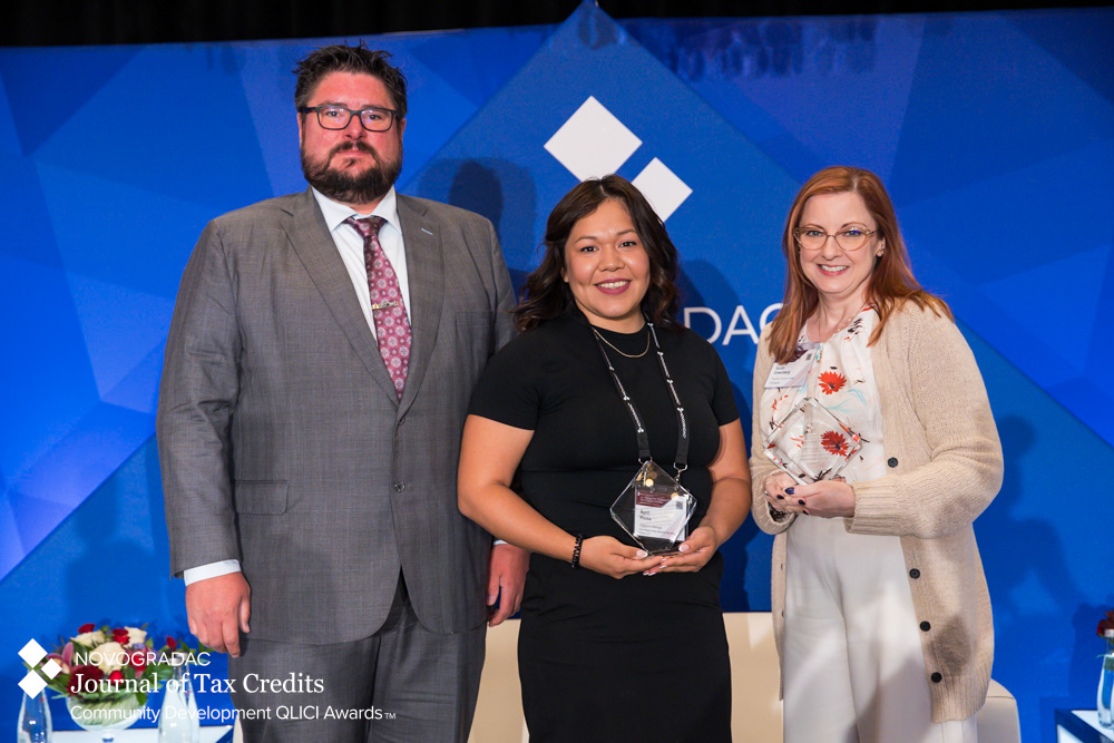 Cinnaire's tweet photo. Cinnaire Lending President Sarah Greenberg was honored to join April Rivas to accept the @NovogradacCPAs QLICI Award for the Marshall County Career Innovation Center. Learn how this project is expanding opportunity &amp; driving impact in Indiana: https://t.co/wBSXsAzonS

#NovocoNMTC https://t.co/Pmxa2C3JNc