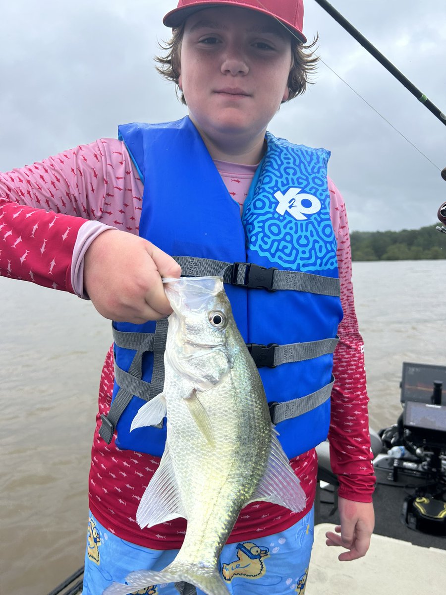 First catch of the day at Aaron Barton’s fishing camp. Weather has been dicey, but the kids are hanging tough at Enid.