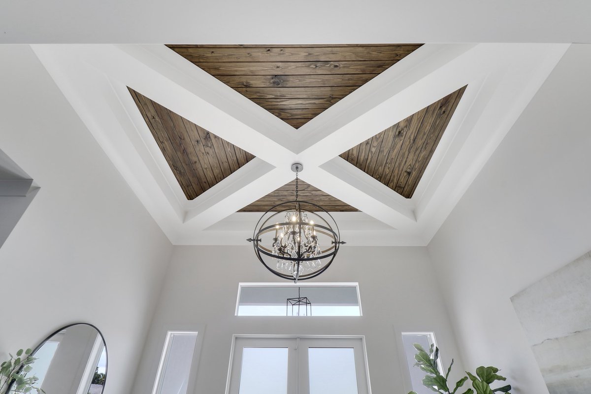 Crafted and curated by @puyolenterprise, this custom foyer features soaring coffered ceilings with handcrafted wood inlays, a statement chandelier, and refined finishes that embody timeless luxury and artisan craftsmanship. puyolenterprise.com
