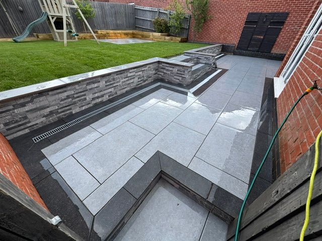 Just look at this stunning patio created by Clean cut landscapes &amp; driveways.

They've expertly crafted this stunning outdoor space with our beautiful Blue Stone Mist Porcelain 900x600, complemented by the sleek Noir Black Porcelain 900x200, and New York Grey Wall Cladding.

#diy