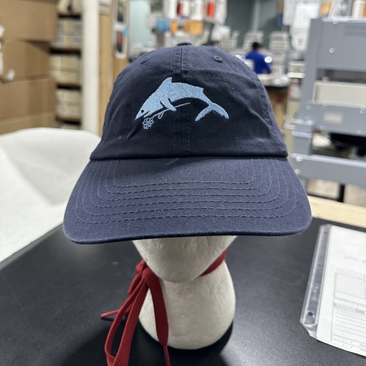 Radiolab's tweet image. First reveal of our new hat! It’s a celebration of our Swimming with Shadows series. YOU CAN GET ONE by joining our membership program. You’ll get ad-free listening, and a hat to protect you from the real danger of summer — not sharks, but UV radiation. members.radiolab.org