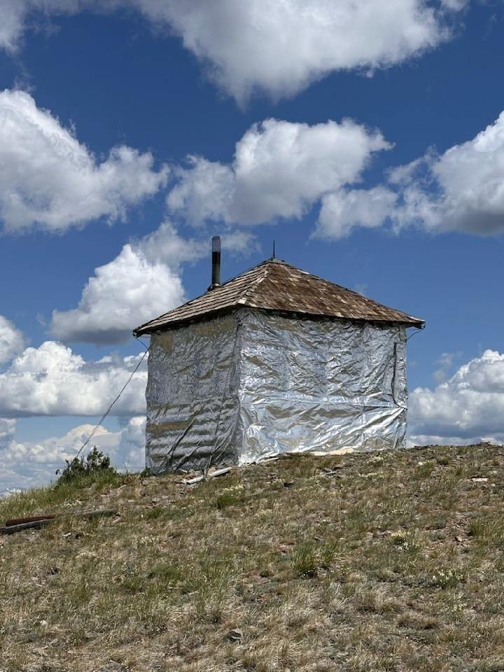 BridgerTetonNF's tweet photo. #DYK as part of the firefighting effort on the #Horse fire, the Prospect Peak Lookout tower was wrapped to protect it during the wildfire. Firefighters used an aluminized structure wrap designed to deflect radiant heat and embers to wrap the historic structure. #BTNF https://t.co/ld1qvjvMvF