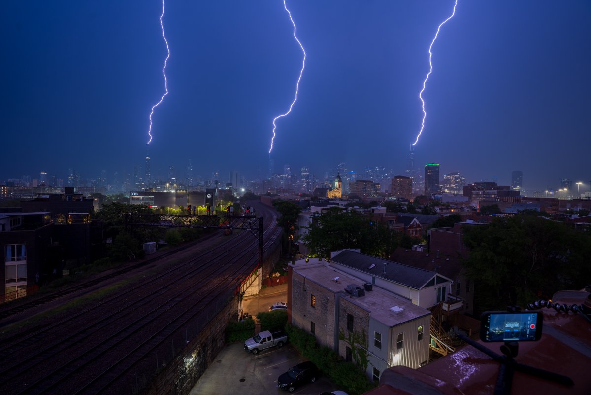 cshimala's tweet image. Triple lightning strike on Chicago at 12:06am on Wednesday!!! The best part of this photo is my old iPhone in the bottom right corner I had recording video. The bolts are visible and so is a "iPhone Storage Full" pop up... oops #ilwx
