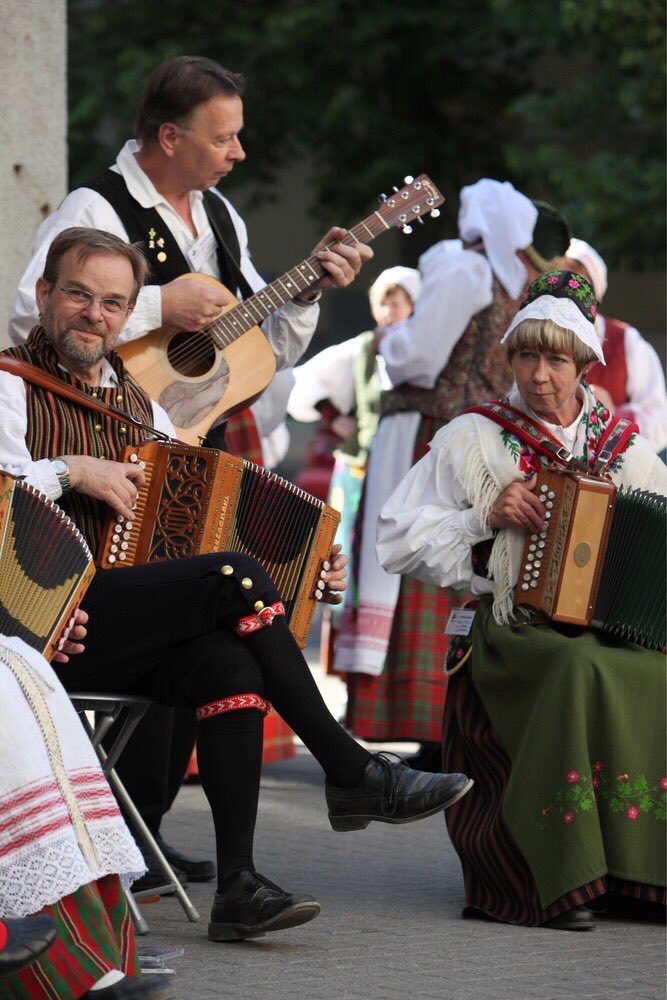 Lithuanian folk performers wearing traditional costumes.