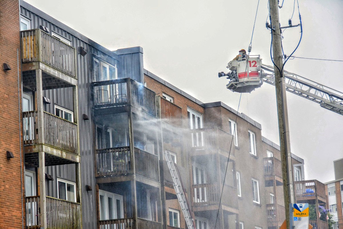 hfxfirefighters's tweet photo. At 9:39 AM, #hfxfirefighters responded to reports of a fire in a three-storey apartment building in Dartmouth. Our members arrived to heavy fire on a second-floor balcony that had extended to the floor above. Our members quickly went to work, with an aggressive fire attack supported by an aerial. A second alarm was required to bring the fire under control.

This same building was the site of a major third-alarm fire in 2018.

Our aerials only have two professional fire fighters—below both industry and manufacturer recommendations. To operate them properly on scenes like this, fire fighters must be pulled from other units, leaving other critical fire ground tasks short. Robbing Peter to pay Paul isn’t how a fire service should function.

In 2024, HRM met its own response time standards for an effective firefighting force just 54.5% of the time—and those standards already fall short of NFPA recommendations. Staffing our aerials with a full crew of four fire fighters would not only improve safety on scene but also help boost these response numbers. 

#HPFFAlwaysOnDuty 
📸 @HfxMda