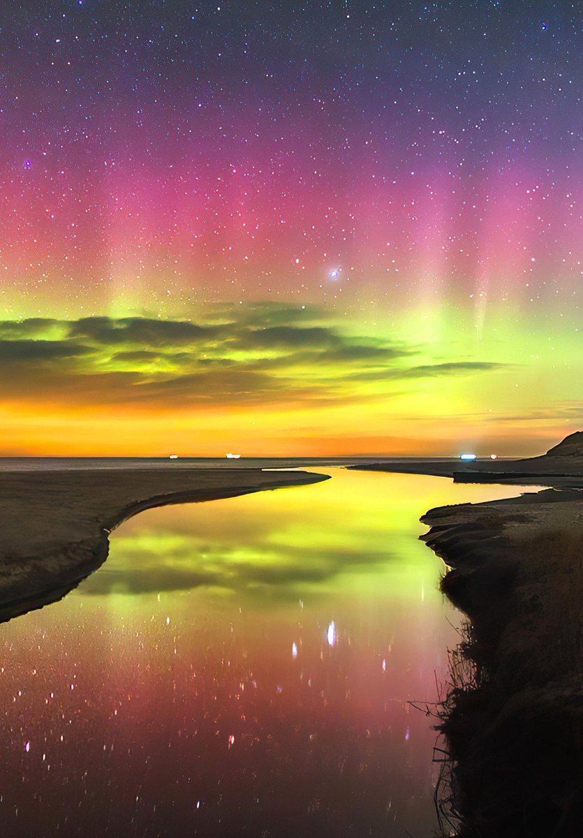 Horizon clouds and rare colored Auroras filmed during a midsummer night in Norway. Northern Lights reflection on the river water amplifies their visibility  🇳🇴