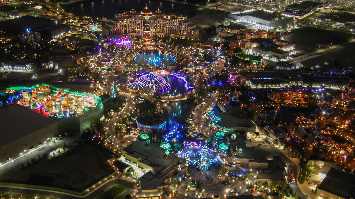 Aerial overview of Epic Universe at night.