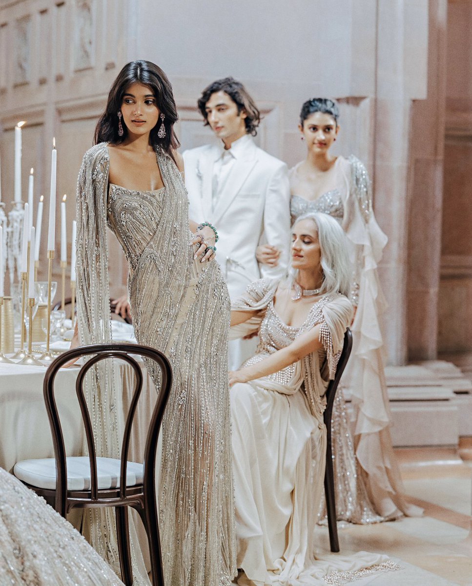 Summer Haze
Gaurav Gupta Couture

Nayonika wears the Flared Crystalline Lehenga paired with a sculpted blouse and cape. Cascading crystal drop bead embroidery catches the light like refracted glass.

Manya wears the Corseted Wrap Drape Saree Gown adorned with the house’s