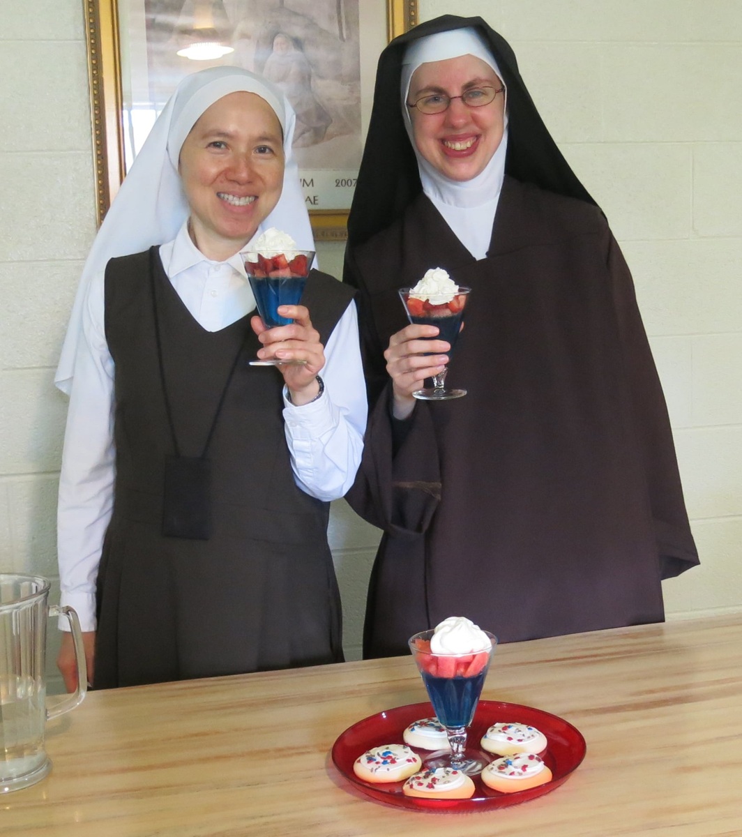 NunsHolding's tweet image. Two Carmelite Nuns of the Carmel of Mary Monastery in Wahpeton, North Dakota holding red, white, and blue desserts. Photo from the Sisters' Facebook page at facebook.com/CarmelofMary/p….