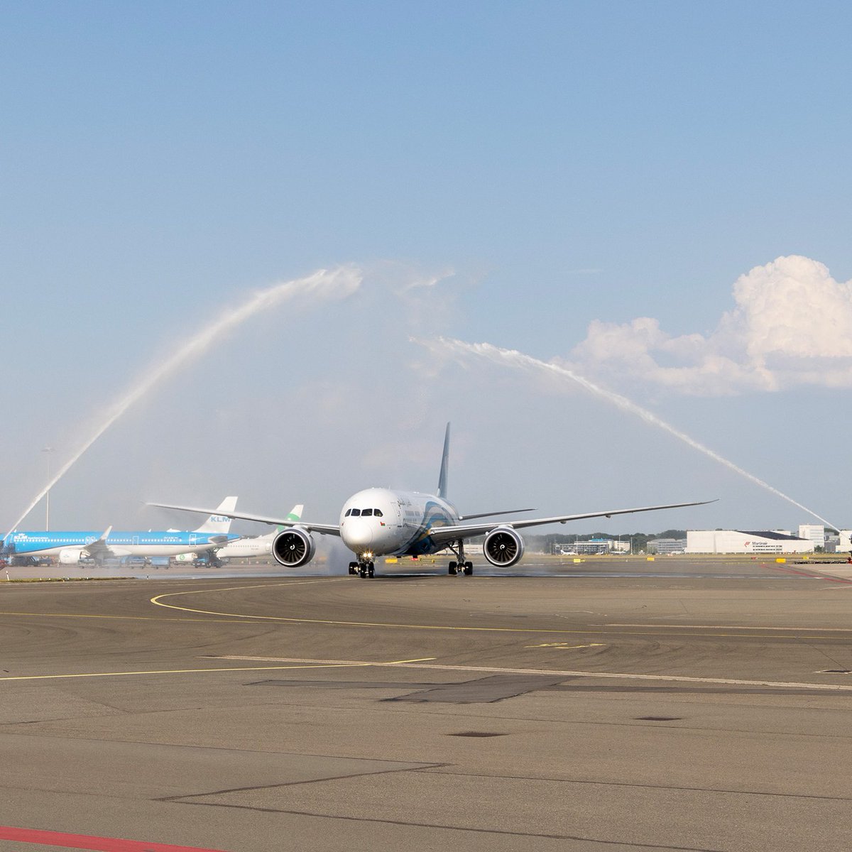 omanair's tweet photo. We love a grand entrance. 🤩✈️

Our inaugural flight to Amsterdam landed at @schiphol yesterday. https://t.co/viwYfGKdYd