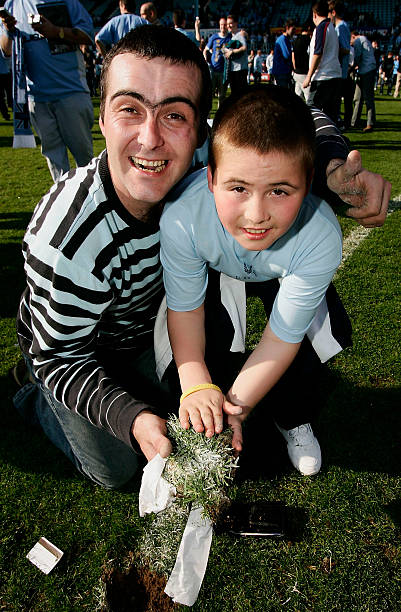 Who is this father and son taking a piece of the highfield road pitch after the final game there v Derby in 2005