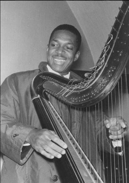 John Coltrane playing  Alice Coltrane's harp (and smiling !!!).