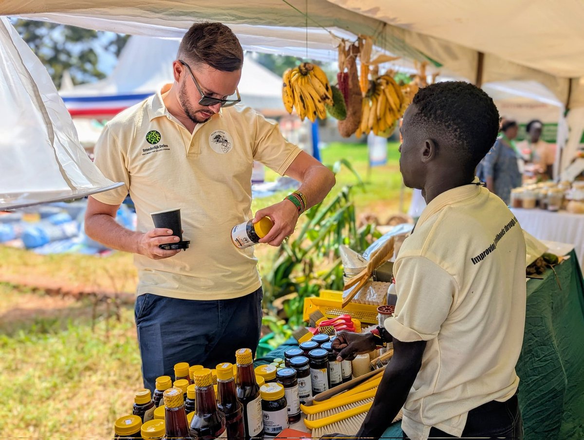We continue to welcome more visitors to the PELUM Uganda Agroecology Village. On the left is Bram Vandewalle from Broederlijk Delen, taking a look at packaged honey from MacBee Honey Harvest Company — a business run by a young female entrepreneur supported under the AAEs/TMs and