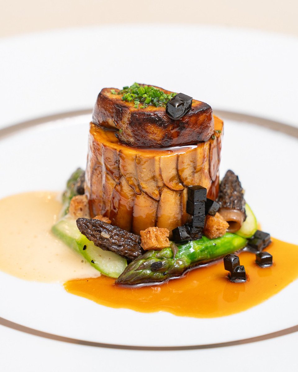 Creedy Carver chicken rolled in chestnut mushrooms, poached, browned in butter, topped with foie gras. Served with English asparagus, morels, black truffle, and two sauces - brioche butter + rich chicken &amp; Madeira. Now on our Paul Ainsworth at No6 à la carte menu.