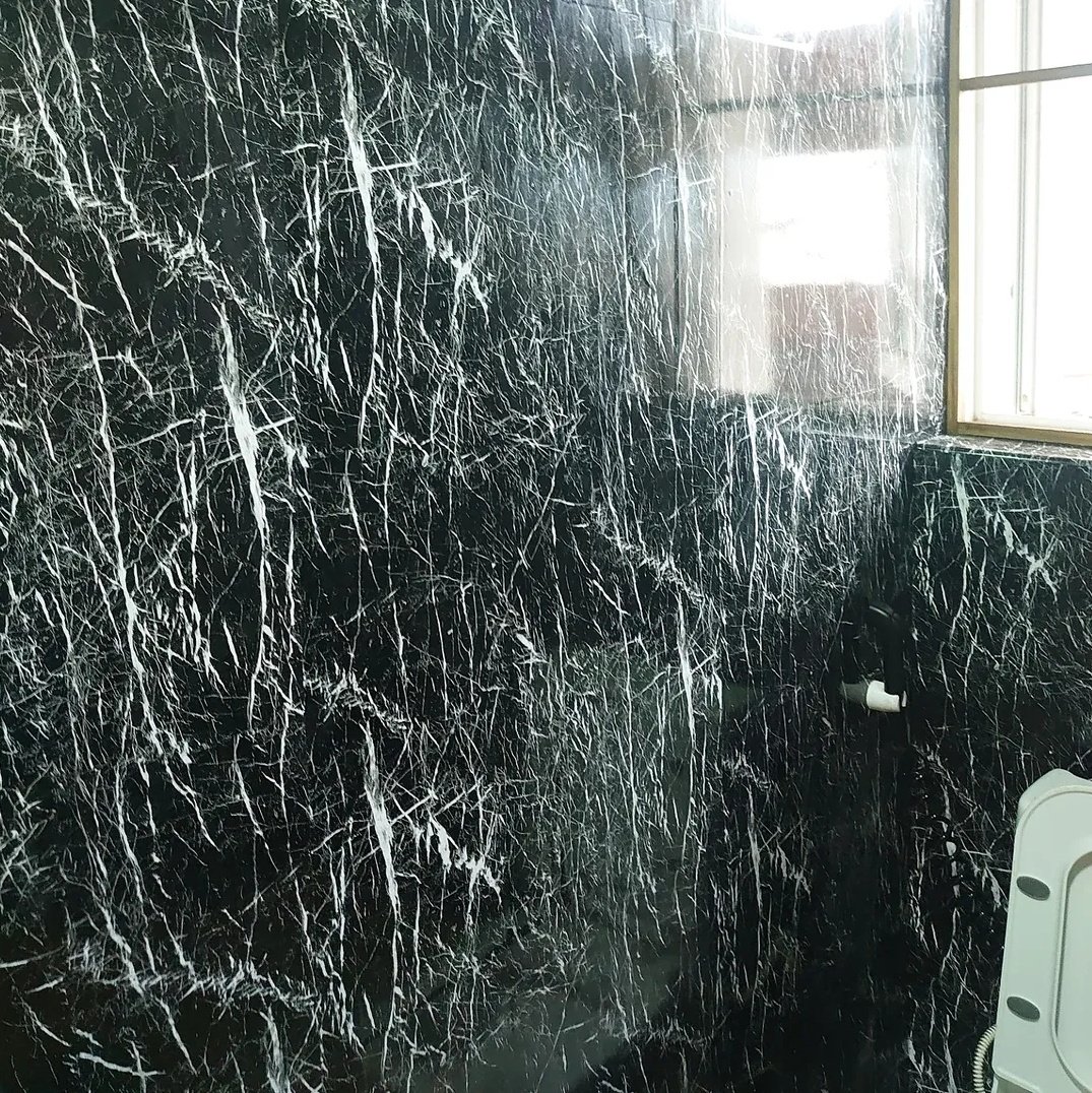 Check out these photos of the work we did in our client's washroom! We put up some glossy black marble contact paper with white stripes, and it looks amazing!