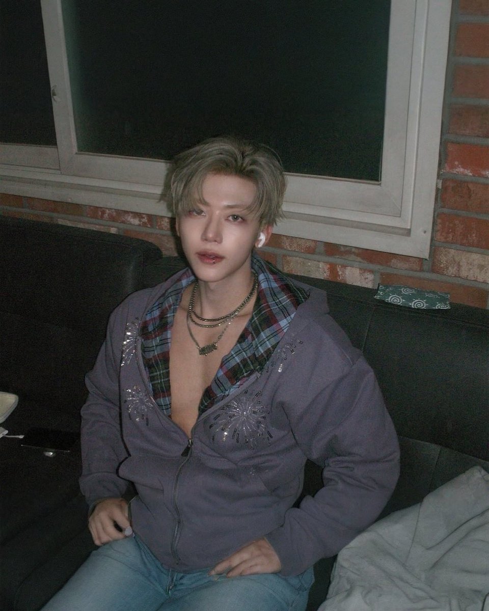 Between shadows and neon lights — I sit quietly while the chaos hums. Soft rebellion never looked this calm.