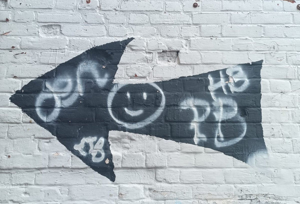 eaglebookshop's tweet photo. Needing to paint over the arrow on our neighbour's wall (in order to stop vehicles getting wedged in the alley) we took the opportunity to have a little graffiti moment. Naughty but nice 😉 https://t.co/n5DHlXmeOh