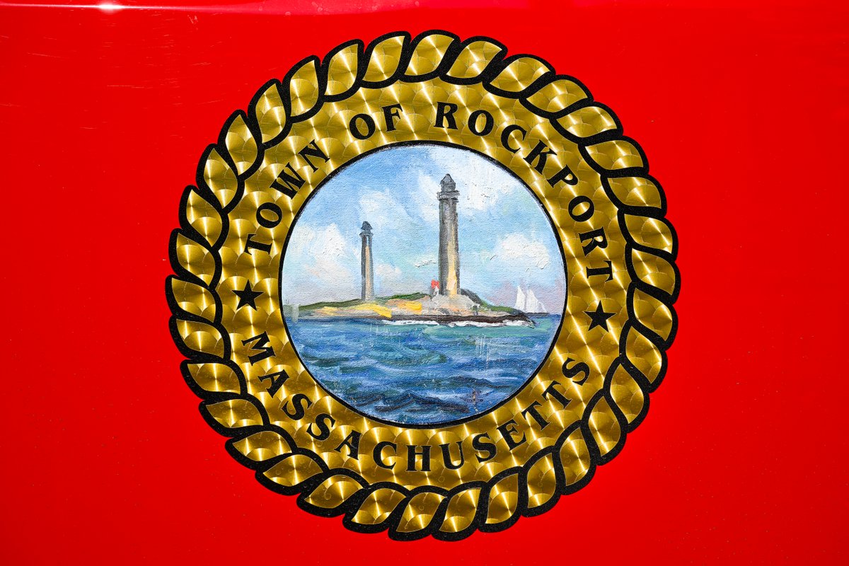 Rockport artist Ken Knowles attaches his oil canvas painting of the Twin Lights to be used as the town seal on the newest Rockport firetruck Combination "A"
