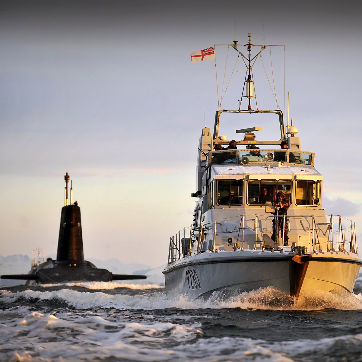 SDA_mod's tweet image. The Royal Navy P2000 Patrol Vessel HMS Dasher is pictured escorting nuclear submarine HMS Vanguard to her berth at HMNB Clyde, following a patrol in 2010.