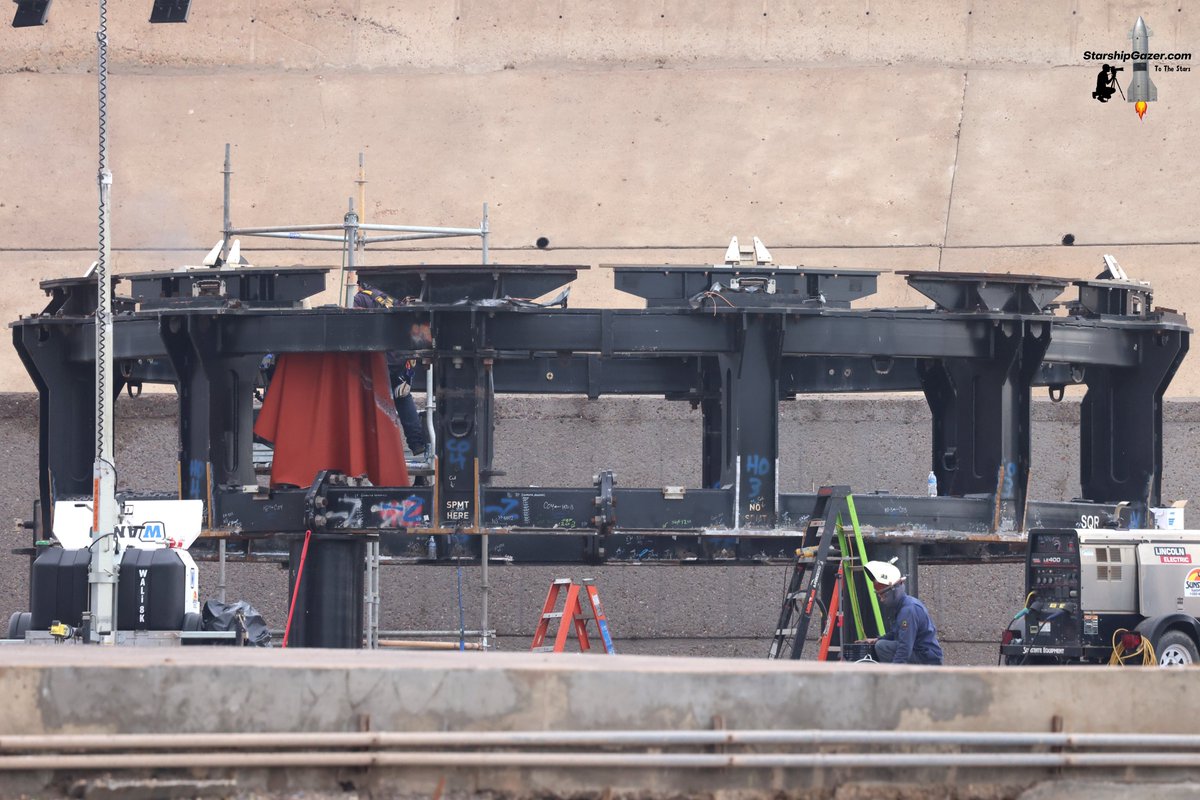 StarshipGazer's tweet image. A look at the Starship transport stand that is being modified into a pad 1 launch mount ship static fire adapter. Lots of grinding, cutting and welding modification work is happening before lifting it onto the launch mount to use for Starship 37 static fire testing.
7/2/25